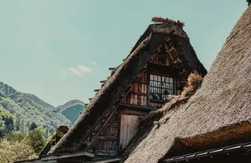 Photo by <a href="https://unsplash.com/@ilvagabiondo?utm_content=creditCopyText&utm_medium=referral&utm_source=unsplash">Il Vagabiondo</a> on <a href="https://unsplash.com/photos/a-house-with-a-thatched-roof-and-mountains-in-the-background-zu-jqKK2QPM?utm_content=creditCopyText&utm_medium=referral&utm_source=unsplash">Unsplash</a>;
