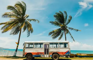 Photo by <a href="https://unsplash.com/@rockstaar_?utm_content=creditCopyText&utm_medium=referral&utm_source=unsplash">Rock Staar</a> on <a href="https://unsplash.com/photos/white-and-blue-bus-near-palm-tree-under-blue-sky-during-daytime-wGyHvtLcW_U?utm_content=creditCopyText&utm_medium=referral&utm_source=unsplash">Unsplash</a>;