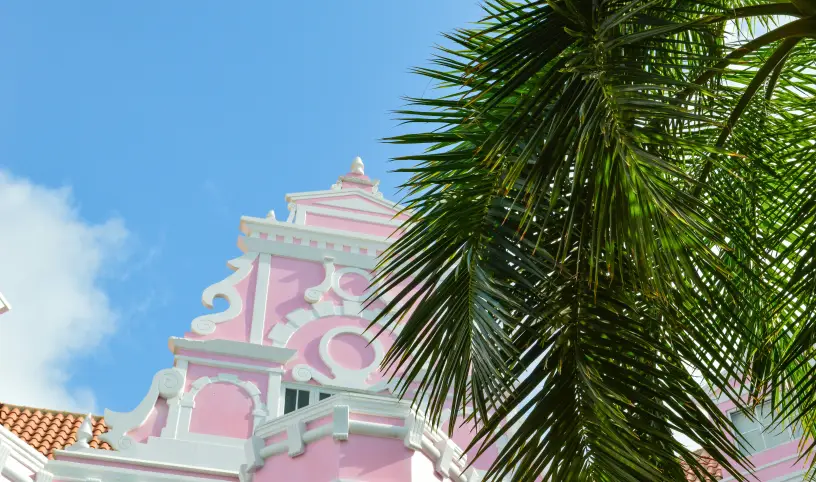 Photo by <a href="https://unsplash.com/@explorethewayside?utm_content=creditCopyText&utm_medium=referral&utm_source=unsplash">Jamie Tudor</a> on <a href="https://unsplash.com/photos/a-pink-and-white-building-with-a-palm-tree-in-front-of-it-9mdVy93KNgM?utm_content=creditCopyText&utm_medium=referral&utm_source=unsplash">Unsplash</a>;